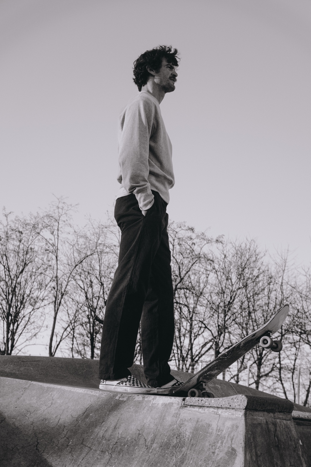 Skateboarder standing on the edge of a bowl